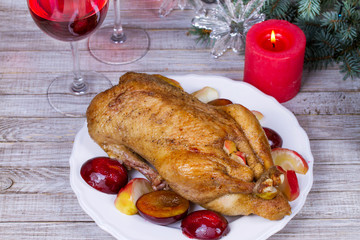 Roast duck with plums and apples