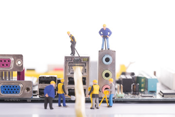 Computer cable Maintenance by figurine engineers with white background