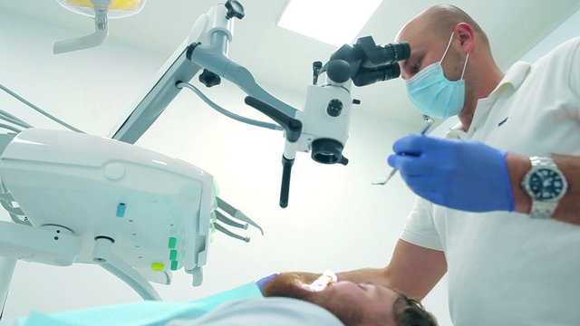 Professional dentist examining the patient