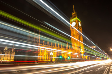 Big Ben, one of the most prominent symbols of both London and England, as shown at night along with the lights of the cars passing by
