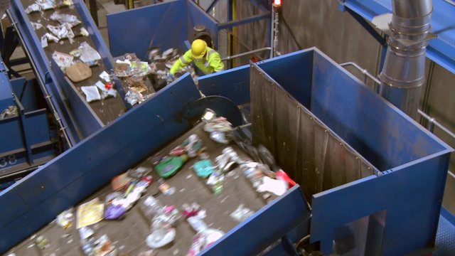 Trash workers on a conveyor