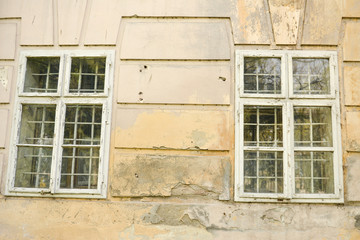 Old damaged wall of a castle with windows