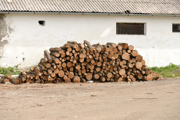 Pile of woods near the wall of the old house