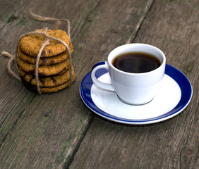 still life a cup of coffee and a linking of oatmeal cookies on a