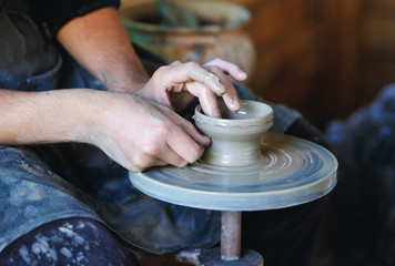 Hands of an artisan working on a potter's wheel