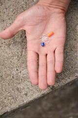 Hand with a unfolded pill