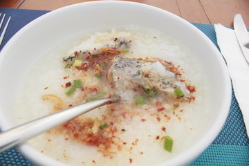 sea bass porridge in white bowl on wooden table