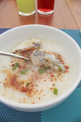 sea bass porridge in white bowl on wooden table