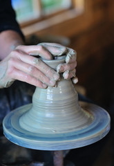 Hands of an artisan working on a potter's wheel