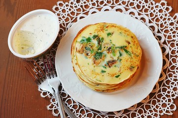 Pancakes with herbs and mushrooms and scrambled eggs for breakfast
