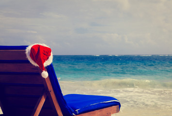 chair lounge with red Santa hat on beach