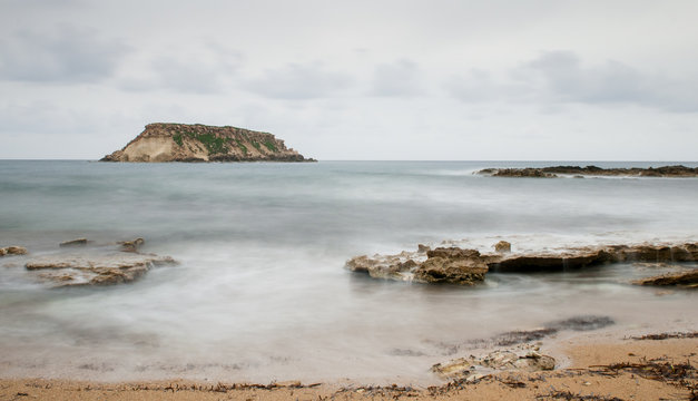 Rocky Seascape with the island of  geronisos
