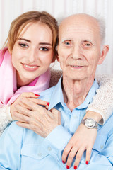 Senior man with her caregiver at home