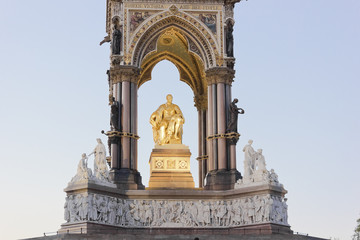The iconic gold gilded statue of Prince Albert by John Henry Foley illuminated at night at the...