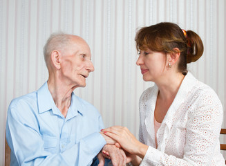 Senior Man, Woman with their Caregiver at Home.