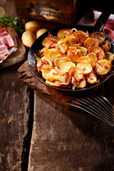 Tasty autumn meal with potato slices and bacon