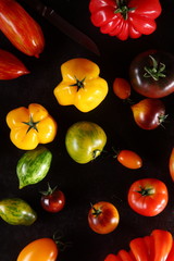Colorful assorted tomatoes on a dark background