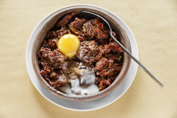 pieces of meat stewed in a clay bowl