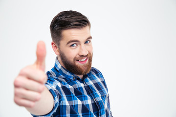 Portrait of a smiling casual man showing thumb up