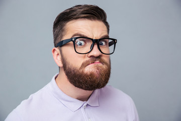 Funny hipster man looking at camera