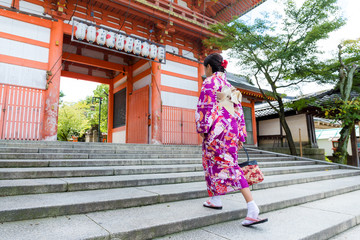 Woman wear with kimono walking though the step in temple