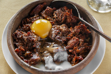pieces of meat stewed in a clay bowl
