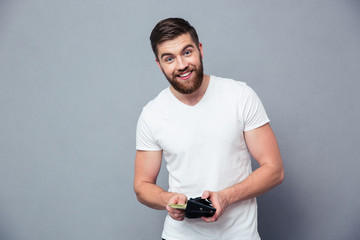 Portrait of a happy man holding wallet with money