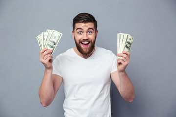 Cheerful man holding dollar bills