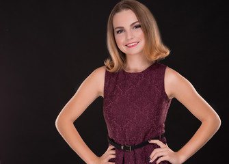 Portrait of smiling beautiful brunette woman on black background