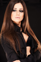 Naklejka premium Portrait of beautiful woman with long hair on black background