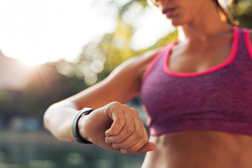 Runner checking her fitness smart watch device