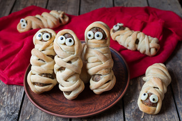 Scary halloween food meatball sausage mummies wrapped in dough