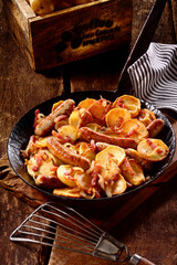 Delicious dish of potatoes, Nuremberger bratwurst and bacon