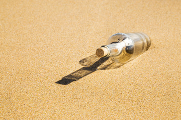 Fototapeta na wymiar Message in a bottle on the beach