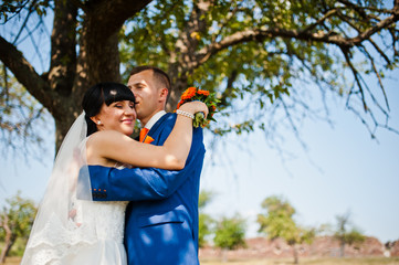 wedding couple near tree at garden