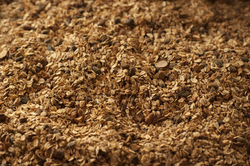 Healthy breakfast. Granola with nuts, seeds, honey, frozen raspberries pumpkin in a wooden biwk on wooden table