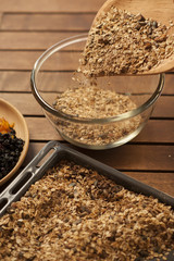 Healthy breakfast. Granola with nuts, seeds, honey, frozen raspberries pumpkin in a wooden biwk on wooden table