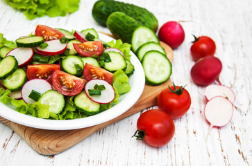 Spring salad with tomato, cucumbers and radish