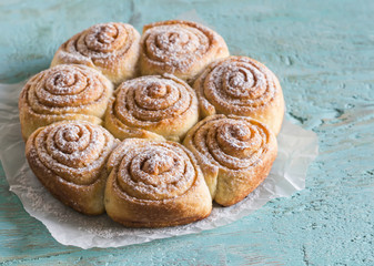 cinnamon rolls on bright wooden surface