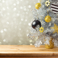 Christmas tree and decorations over bokeh lights background. Black, golden and silver ornaments