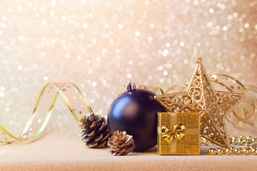 Christmas decorations in black and gold over glitter sparkle background