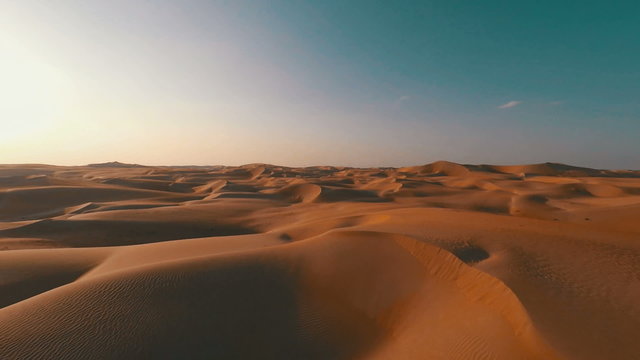 Flying backwards over picturesque sand dunes in the Arabian desert