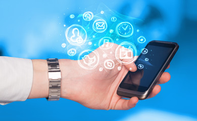 Hand holding smartphone with mobile app choices