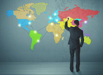 businessman drawing map on wall