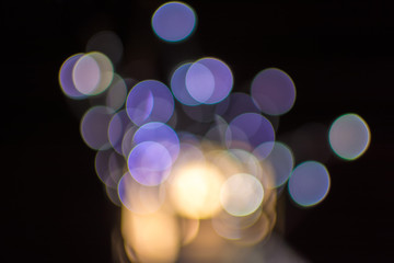 Defocused bokeh Christmas lights on a wooden support