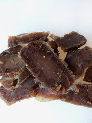 Biltong snack piled up on white paper