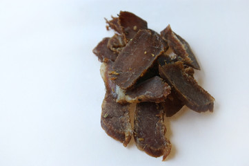 Biltong snack piled up on white paper