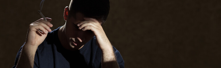 Troubled man smoking a cigarette