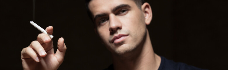 Young smoker holding a cigarette