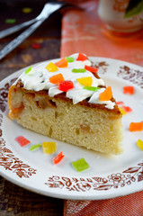 Celebration cake with vanilla sause, decorated candied fruits